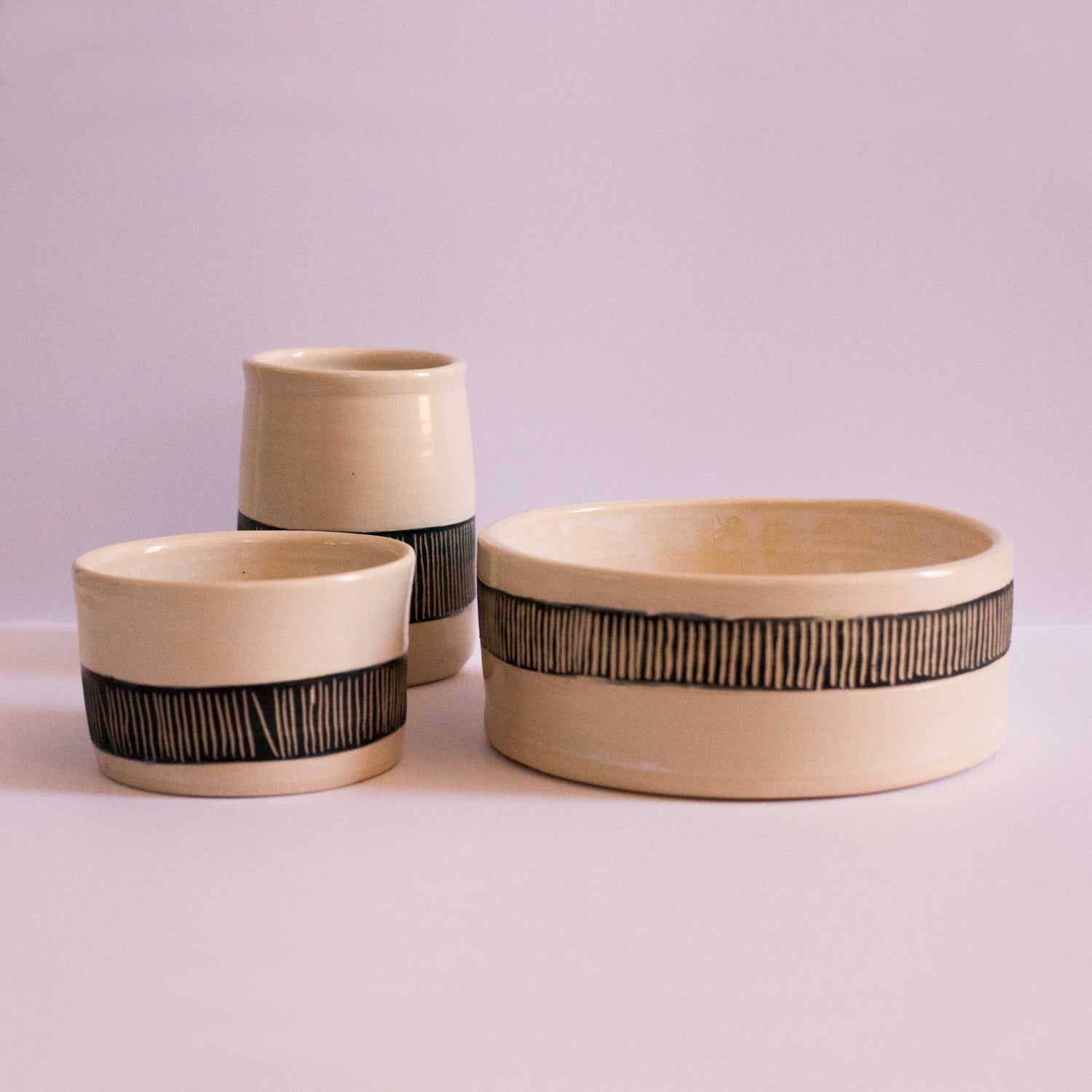 A Earth and Nectar handmade functional pottery set featuring a vase, small soup bowl and large salad bowl 